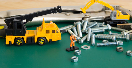 small worker figure with hardware material