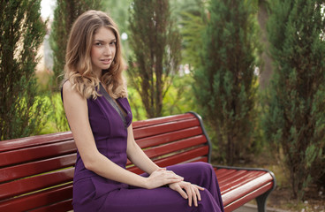 Portrait Of Young Beautiful Woman. beautiful young brunette fashion model posing outdoor. Summer outdoor portrait. Focus on woman, blurred background