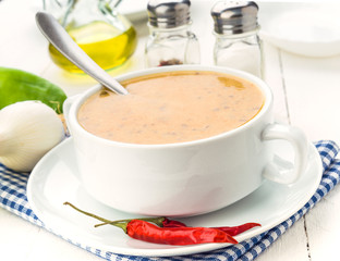 spicy vegetable soup with chili, on wooden board