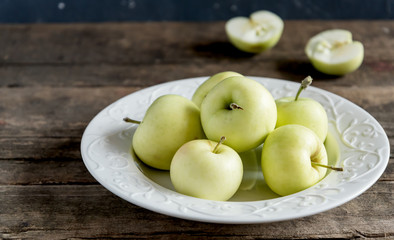 Naklejka na ściany i meble Fresh and juicy apples on white plate