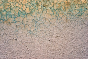 Old cracked wall background in green and gold colors in the top