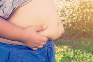 Boy fat and unhealthy with natural light vintage background.