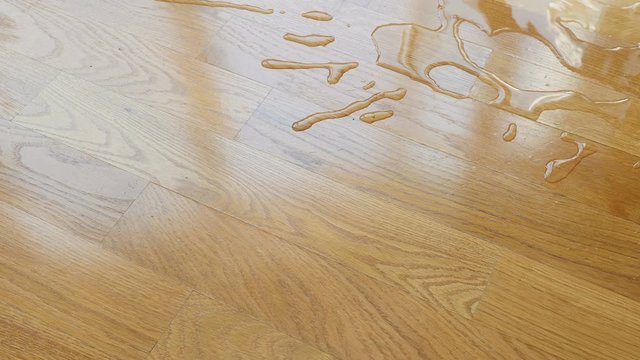 Parquet. Drops of water on wooden surface.