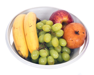 Organic fruits in berry bowl separated on white background