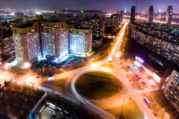 Fototapeta na wymiar Highway at night in modern city. Aerial view of cityscape