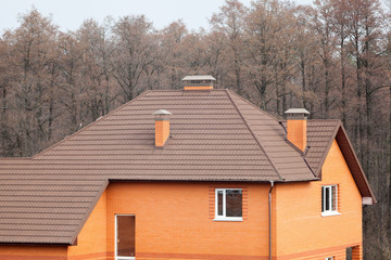 New brick house with modular chimney, Stone Coated Metal Roof Tile, plastic windows and rain gutter