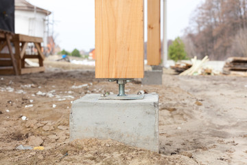 Wooden pillar on the construction site concrete with screw. Wooden Pillars are structures that can...