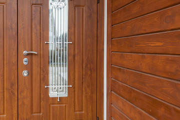 Modern style metallic door handle on wooden door