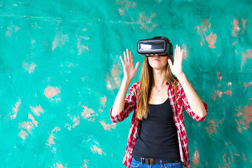 technology, entertainment and people concept - happy young woman with virtual reality headset or 3d glasses