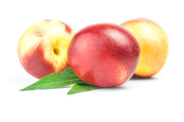 Three big fresh ripe nectarines on white background