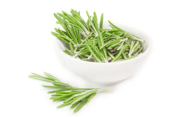 Fresh rosemary in a bowl on white