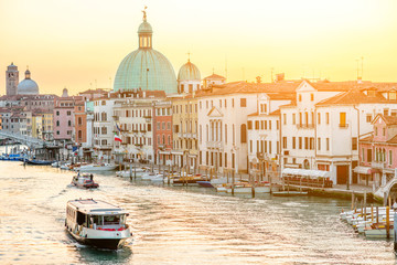 Venice cityscape view on the Grand canal with dome of San Piccolo Simeone church at the sunrise