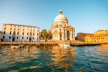 Beautiful waterfront with gothic buildings and Santa Maria basilica on the Grand canal at the morning in Venice