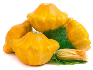 four yellow pattypan squash with leaf and flower isolated on white background