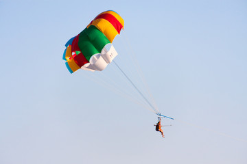 tourist attraction parasailing on cloudy sky background