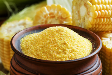 Raw corn grits or polenta in a clay pot, selective focus © 5ph