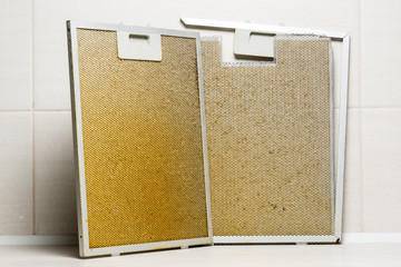 A dirty, greasy aluminum filter for cooker hood