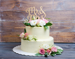 two  layered wedding cream cheese cake with roses and eustoma