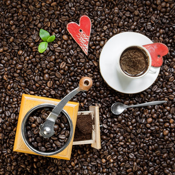 Cup of coffee and coffee grinder