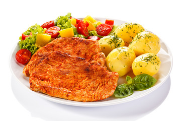 Fried chicken fillets, boiled potatoes and vegetable salad 