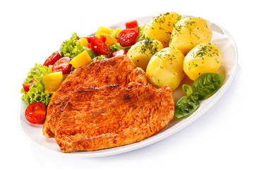 Fried chicken fillets, boiled potatoes and vegetable salad 