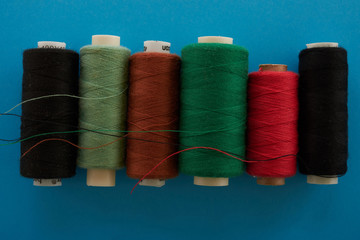colored the threads lying on a blue background