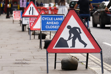 Cycle Lane Closed to Cyclists due to road works showing safety signs.