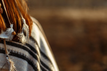 back of boho woman walking in mountains in eve