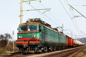 Fototapeta na wymiar front of old train crossing railway and transporting goods carri