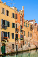 Canal with beautiful medieval facades. Venice, Italy.