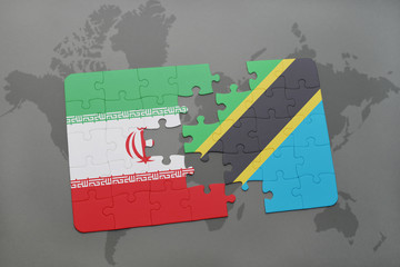 puzzle with the national flag of iran and tanzania on a world map background.