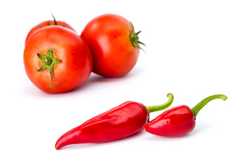  tomatoes and hot peppers white background