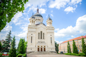 Obraz premium Orthodox Cathedral in Cluj-Napoca Avram Iancu Square in the Transylvania region of Romania on a beautiful sunny summer day with a blue cloudy sky