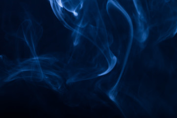 Cloud of smoke on black background. Selective focus. Toned