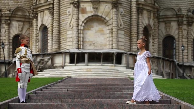 Young children's dance couple. Waltz dance on the lawn in the park
