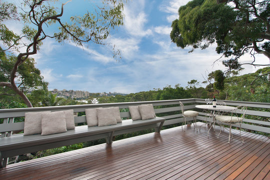 Back Yard With Outdoor Seating And Barbecue With Family