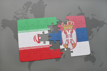 puzzle with the national flag of iran and serbia on a world map background.