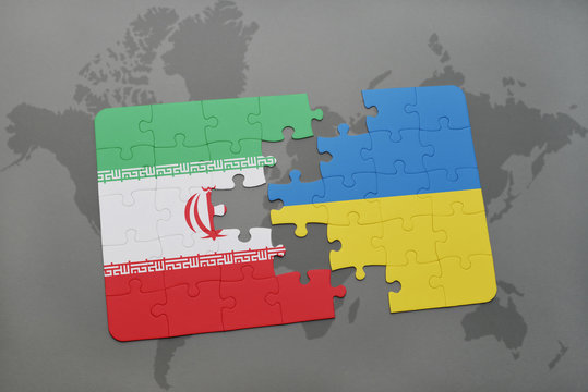 Puzzle With The National Flag Of Iran And Ukraine On A World Map Background.