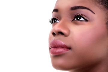 Close up or closeup of black African American visionary woman in eye makeup with copy space