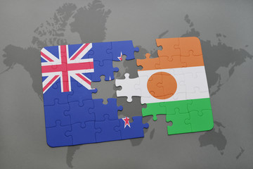puzzle with the national flag of new zealand and niger on a world map background.