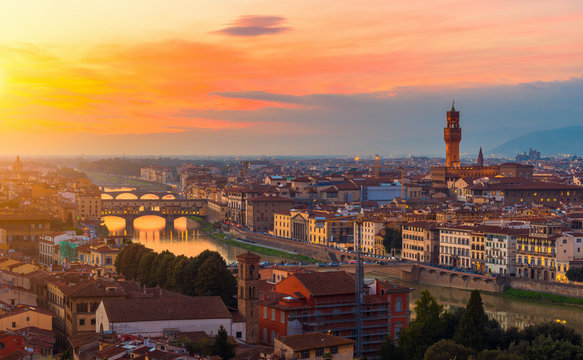 Sunset view of Ponte Vecchio over Arno River and Palazzo Vecchio in Florence, Italy
