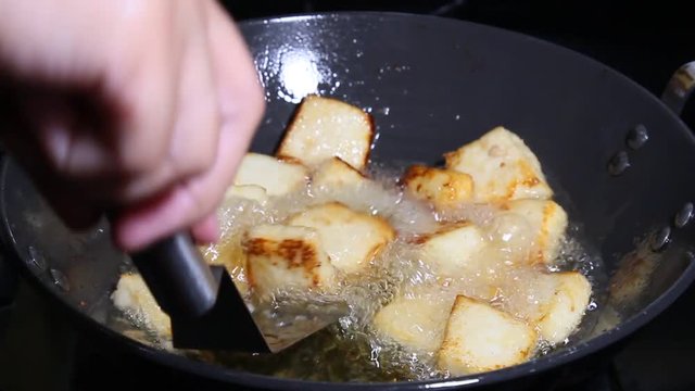 Frying Paneer cheese cubes in oil