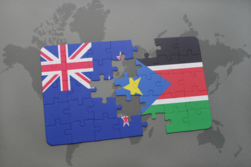 puzzle with the national flag of new zealand and south sudan on a world map background.