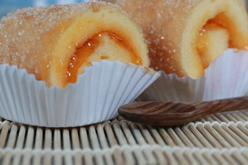 Orange jam roll so sweet with the sugar in the paper cup, closed up