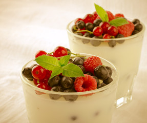 Sweet dessert, pudding, panna cotta with mix berries and mint