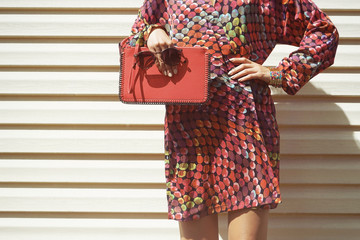 Naklejka premium Young woman with fashion details on planks background