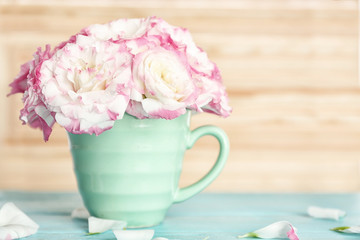 Obraz na płótnie Canvas Beautiful flowers in vase on light background