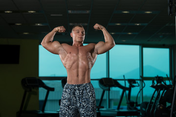 Fototapeta na wymiar Healthy Young Man Flexing Muscles