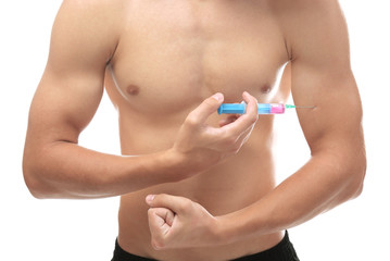 Sportsman injecting himself with steroids on white background