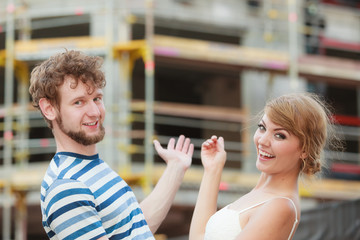 Couple on front of new house. Real estate